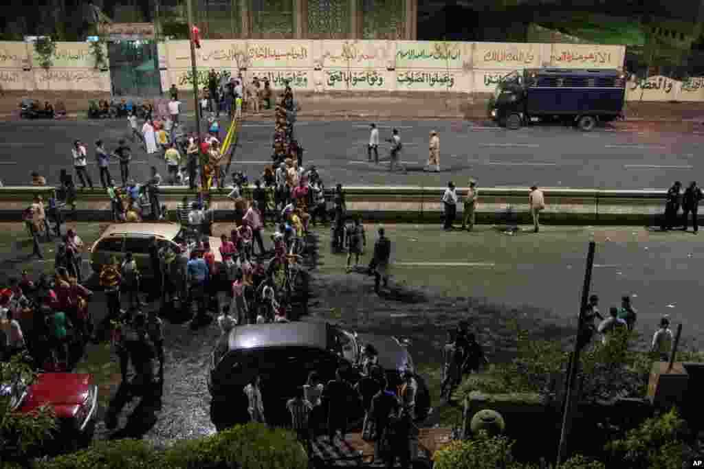 Egyptians gather outside of a national security building after a bomb exploded in the Shubra el-Kheima neighborhood of Cairo injuring several people according to security officials, early Aug. 20, 2015.