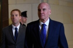 Michael McKinley, right, the top aide to Secretary of State Mike Pompeo, arrives testify at a closed-door deposition on Capitol Hill in Washington, Oct. 16, 2019.