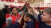 Head coach Geno Auriemma, center, joins Candace Parker, left, and the rest of the US women's basketball Olympic team in a huddle as they complete practice Friday, May 11, 2012, in Seattle.