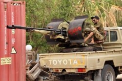 FILE - Fighters loyal to the UN-recognized Libyan Government of National Accord (GNA) are pictured during clashes with forces loyal to strongman Khalifa Haftar in an area south of the Libyan capital Tripoli on June 1, 2020.