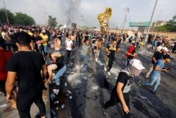 Demonstrators take part in a protest over unemployment, corruption and poor public services, in Baghdad, Iraq, Oct. 2, 2019.