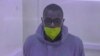 FILE - This video grab from an AFPTV video taken on Jan. 21, 2022 in Kampala shows Kakwenza Rukirabashaija appearing in court via a video link from prison on charges of 'offensive communication.' 