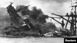 The battleship USS Arizona sinks after being hit by a Japanese air attack on Pearl Harbor, Hawaii, Dec. 7, 1941. 