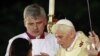 People attend a mass celebrated by Pope Benedict XVI in Antonio Maceo square in Santiago, Cuba, March 26, 2012.