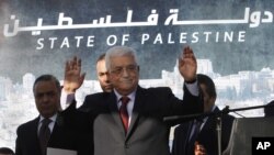 Palestinian President Mahmoud Abbas, waves to the crowd during celebrations for their successful bid to win U.N. statehood recognition in the West Bank city of Ramallah, December 2, 2012.