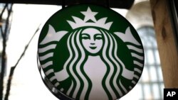 FILE - This is a sign in a Starbucks located in downtown Pittsburg, Pennsylvania, 24, 2018. Starbucks is getting rid of plastic straws at its locations around the world. 