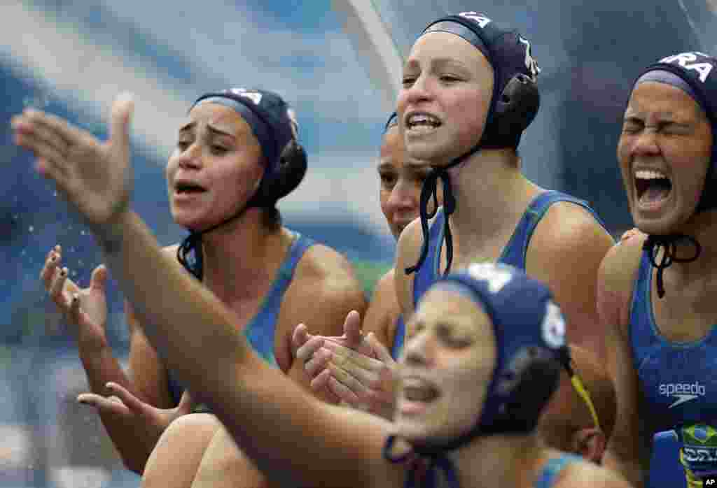 Brazil players cheer their teammates during a preliminary women's water polo match against Russia at the Summer Olympics in Rio de Janeiro, Brazil.