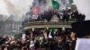 Algerians climbed on the iconic Marianne statue in downtown Paris, France, March 3, 2019.