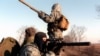 FILE - A Russian soldier aims his rifle in the outskirts of Grozny, March 19, 1996. By that time, at least 30,000 people had been reported killed in the fighting after Moscow sent its troops into Chechnya in December 1994 to halt independence moves.