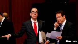 U.S. Treasury Secretary Steven Mnuchin talks with a delegate during the G-20 finance ministers and central bank governors meeting in Fukuoka, Japan, June 8, 2019. 