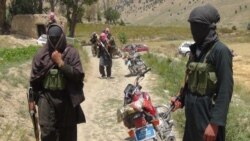 FILE - Taliban fighters stand with their weapons in Ahmad Aba district, on the outskirts of Gardez, the capital of Paktia province, Afghanistan, July 18, 2017.