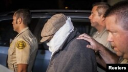 Nakoula Basseley Nakoula (C) is escorted out of his home by Los Angeles County Sheriff's officers in Cerritos, California, September 15, 2012. 