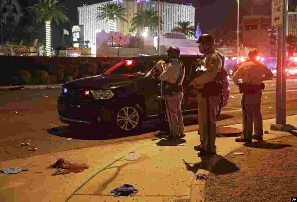 Police stand at the scene of a shooting along the Las Vegas Strip, Oct. 2, 2017, in Las Vegas.