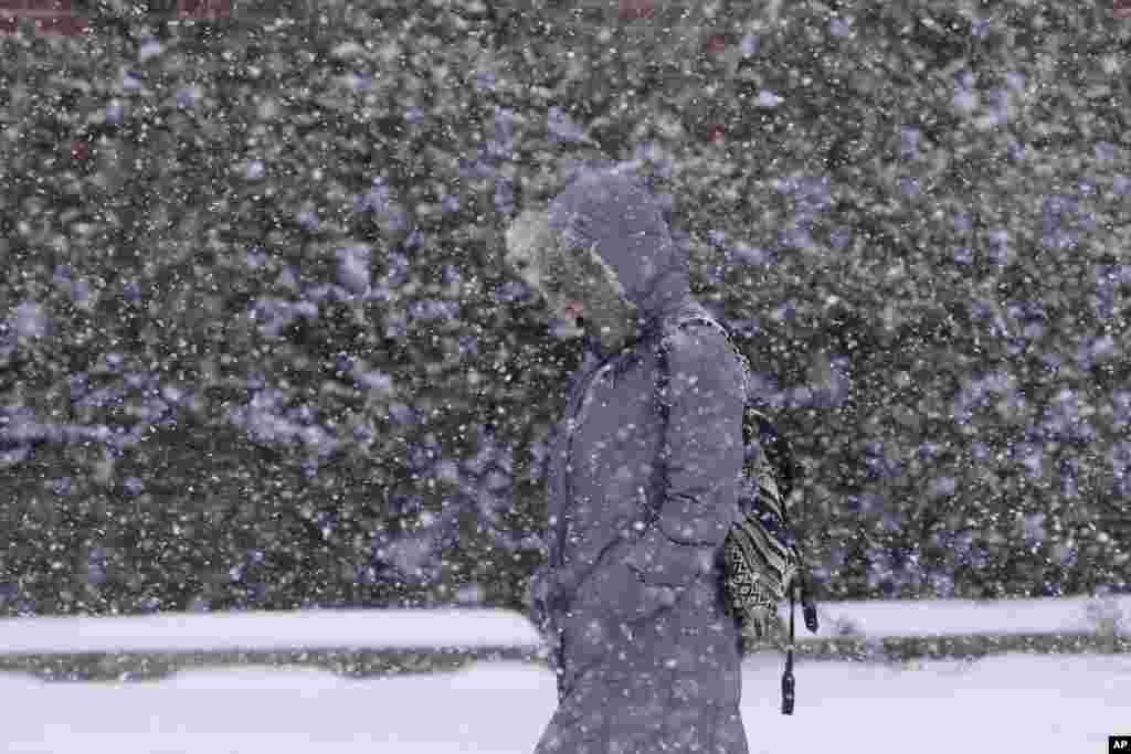 A pedestrian walks through a snow storm, in south Philadelphia, Pennsylvania, USA. The National Weather Service said the storm could bring 8 to 12 inches of snow to Philadelphia and New York City, and more than a foot in Boston.
