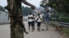 FILE - School-going pupils from the Democratic Republic of Congo cross the Mpondwe border point separating Uganda and the DRC, Aug. 14, 2019. 