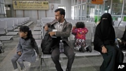 A Yemeni family waits in the departure hall at Sanaa International airport for a U.N. flight, Yemen, Feb. 3, 2020. The United Nations medical relief flight carrying patients from Yemen's rebel-held capital was the first in over three years. 