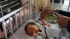A newborn baby is cared for at the Ataturk Children's Hospital a day after being rescued from a deadly attack on another maternity hospital, in Kabul, Afghanistan, May 13, 2020. 