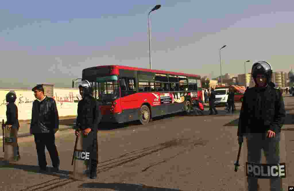 Egyptian police stand guard after an explosion hit a public bus in Cairo's eastern Nasr City district, Dec. 26, 2013.