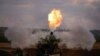 A Palestinian firefighter participates in efforts to put out a fire at a sponge factory after it was hit by Israeli artillery shells, according to witnesses, in the northern Gaza Strip, May 17, 2021.