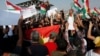 Syrian Kurds protest the Turkish offensive against Syria during a demonstration in front of the United Nation Headquarter in Erbil, Iraq Oct. 10, 2019. 