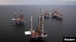 FILE - Oil rigs sit in the Gulf of Mexico, Aug. 11, 2010.