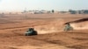 Kurdish peshmerga fighters drive vehicles at the front line during a battle with Islamic State militants at Topzawa village near Bashiqa, Iraq, Oct. 24, 2016. 