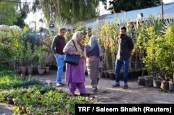 A family looks at plants at a nursery in H-9 neighborhood of Islamabad, Pakistan’s capital, March 7, 2018.
