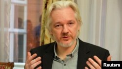 FILE - WikiLeaks founder Julian Assange gestures during a news conference at the Ecuadorian embassy in central London, Aug. 18, 2014. 