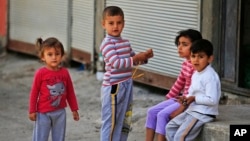 FILE - Syrian refugee children pass time in a neighborhood of the city of Gaziantep, southeastern Turkey on May 16, 2016. (AP)