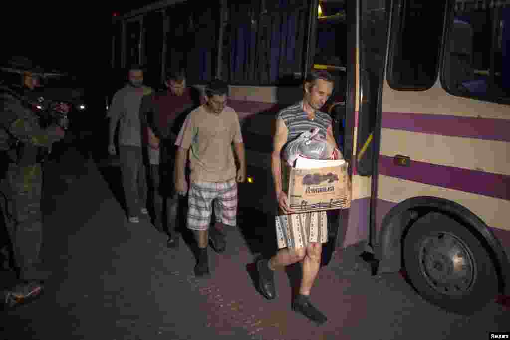 Members of the pro-Russian rebels, who are prisoners-of-war (POWs), walk along a road as they are being exchanged, north of Donetsk, eastern Ukraine, Sept. 12, 2014. 