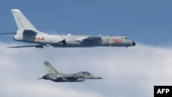 FILE - This photo taken July 22, 2017, by Taiwan's Defense Ministry shows a Taiwanese jet intercepting an H-6 bomber from China over the East China Sea.