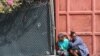 People take cover during clashes between gangs and security forces, in Port-au-Prince