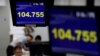 Employees of a foreign exchange trading company work under monitors displaying the Japanese yen's exchange rate against the U.S. dollar in Tokyo, Japan, June 16, 2016.