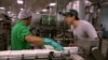 FILE - Gary Chiu of Banyan Foods works in the family business, the oldest tofu factory in Houston, Texas. A new survey finds two-thirds of Americans support free trade.