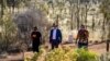 Australian Prime Minister Anthony Albanese, center, walks to a meeting with Indigenous leaders from central Australia in the Uluru Kata Tjuta National Park in central Australia on Oct. 10, 2023.