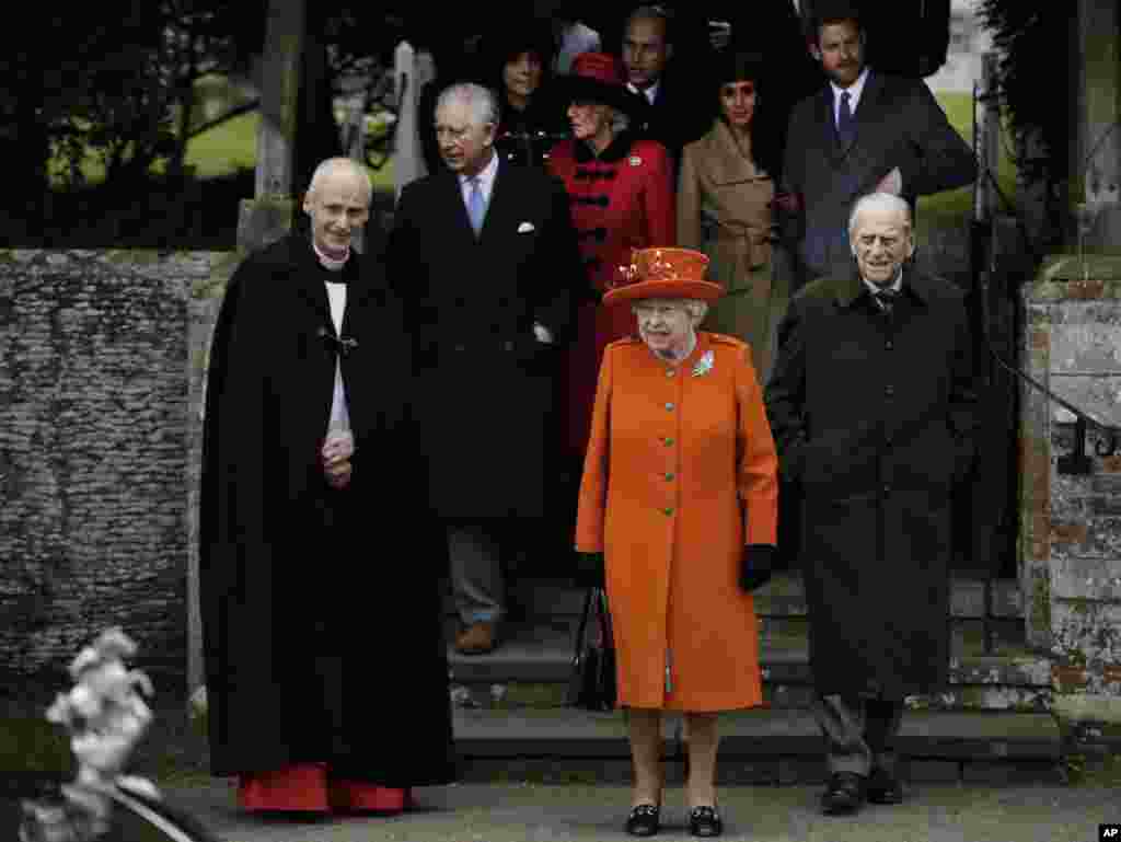 Britain&#39;s Queen Elizabeth II, center, with Prince Philip, right, leave following the traditional Christmas Day church service, at St. Mary Magdalene Church in Sandringham, Dec. 25, 2017.