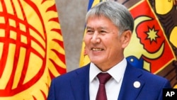 FILE - Kyrgyzstan's President Almazbek Atambayev meets Russian President Vladimir Putin at a Commonwealth of Independent States summit in Bishkek, Kyrgyzstan, Sept. 16, 2016.