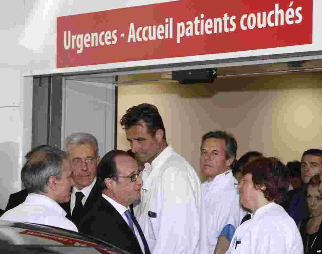 French President Francois Hollande leaves the Pasteur hospital after visiting victims, the day after the Bastille Day truck attack, in Nice, southern France, July 15, 2016.