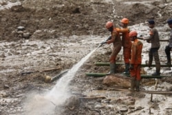Rescuers search for missing people at a village affected by a landslide in Cigudeg, West Java, Indonesia, Jan. 4, 2020.