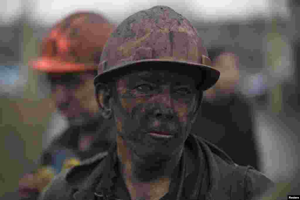 A miner waits for a bus to leave the Zasyadko coal mine after the explosion, in Donetsk March 4, 2015.