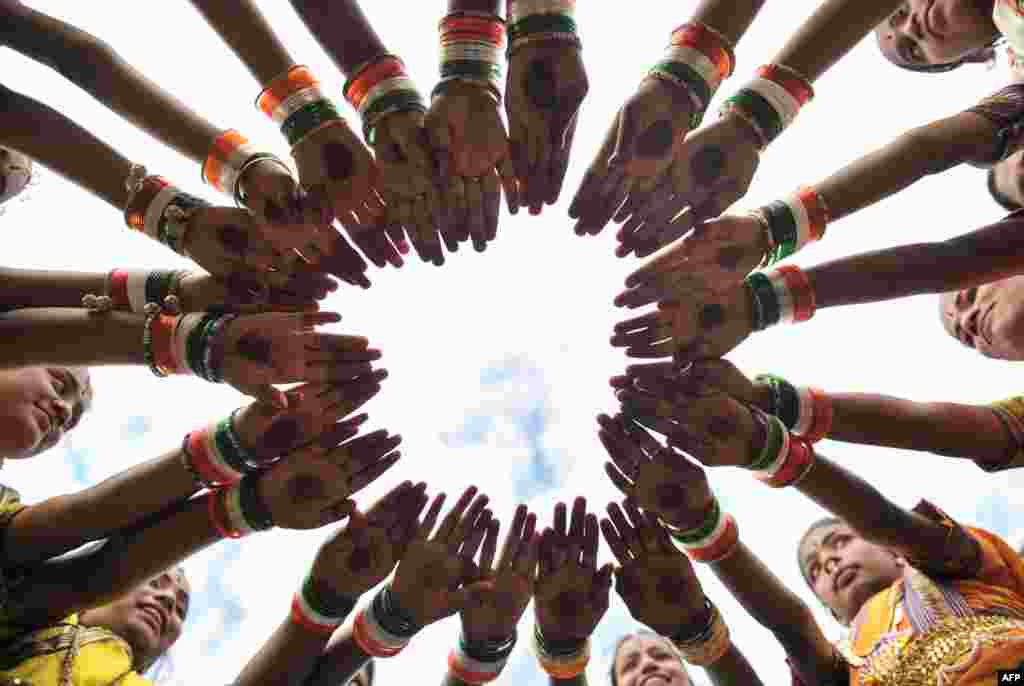 Indian girls wearing tricolor bangles practice during Independence Day celebrations in Secunderabad, the twin city of Hyderabad.
