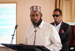 In this Oct. 10, 2018 photo, Mukhtar Robow, who was once deputy leader of Africa's deadliest Islamic extremist group the al-Shabab, speaks at a press conference about his candidacy for a regional presidency, in Baidoa, Somalia.