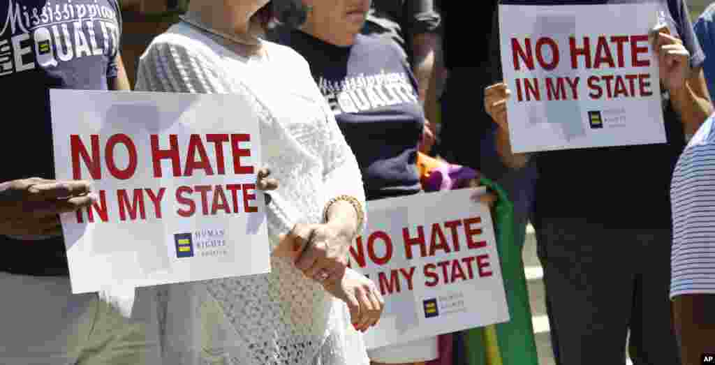 Activists of various groups and denominations gather on the steps of the Capitol in Jackson, Mississippi, to celebrate Thursday&#39;s ruling of a federal judge who blocked a law on religious objections to same-sex marriage, moments before it was set to take effect Friday.