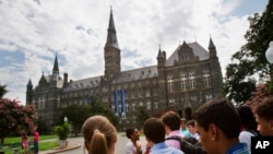 FILE - In this July 10, 2013 file photo, prospective students tour Georgetown University's campus in Washington.
