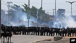 Riot police take position and fire tear gas at protesters gathering near Castelao stadium in Fortaleza, Brazil, June 19, 2013. 