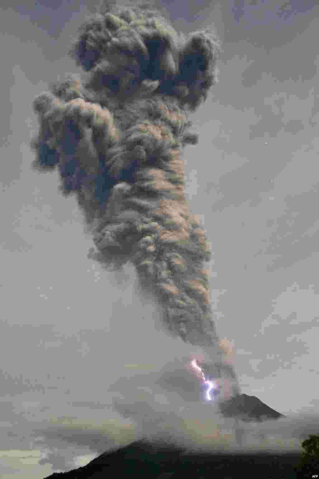 Lighting flashes as Sinabung volcano spews volcanic ash and hot smoke in Karo. Mount Sinabung on western Sumatra island, which has been erupting on and off since mid-September, shot volcanic ash around 10,000 meters into the air, according to Indonesia's Mitigation Agency.