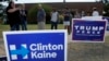 FILE - early voters stand by campaign signs as they wait in line at a voting location in Dallas. 