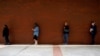 FILE - People who lost their jobs wait in line to file for unemployment benefits, following an outbreak of the coronavirus disease (COVID-19), at Arkansas Workforce Center in Fort Smith, Arkansas, April 6, 2020.