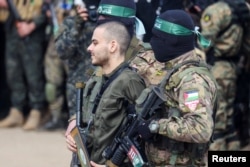 Omer Wenkert, a hostage held in Gaza since Hamas’ deadly Oct. 7, 2023, attack on Israel, is escorted by Hamas militants as he is released in Nuseirat, Gaza Strip, on Feb. 22, 2025.