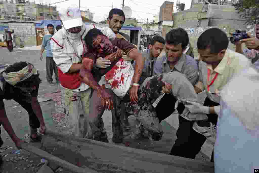 September 19, 2011: Yemeni Anti-government protestors carry Hassan Wadaf, a cameraman wounded in clashes with security forces. Several people were killed in recent days as snipers picked off protesters from rooftops in Sanaa.